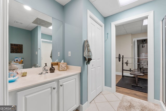 130 Allie Dr, Mcdonough, GA 30252 - bathroom with a drop ceiling, gas water heater, vanity, tile patterned floors, and baseboards