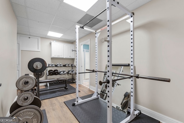 130 Allie Dr, Mcdonough, GA 30252 - exercise area with wood finished floors, a paneled ceiling, and baseboards