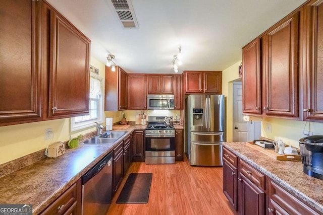 4872 Nature Trl, Austell, GA 30106 - kitchen with stainless steel appliances, a sink, and light wood-style flooring