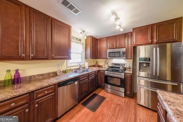 4872 Nature Trl, Austell, GA 30106 - kitchen featuring stainless steel appliances, a sink, and light wood finished floors