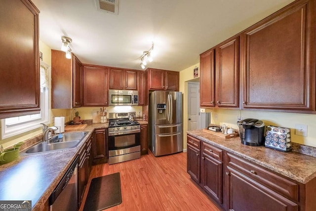 4872 Nature Trl, Austell, GA 30106 - kitchen with appliances with stainless steel finishes, a sink, and light wood-style flooring