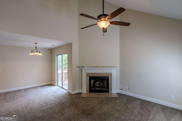 unfurnished living room featuring carpet flooring, ceiling fan, high vaulted ceiling, a fireplace with flush hearth, and baseboards