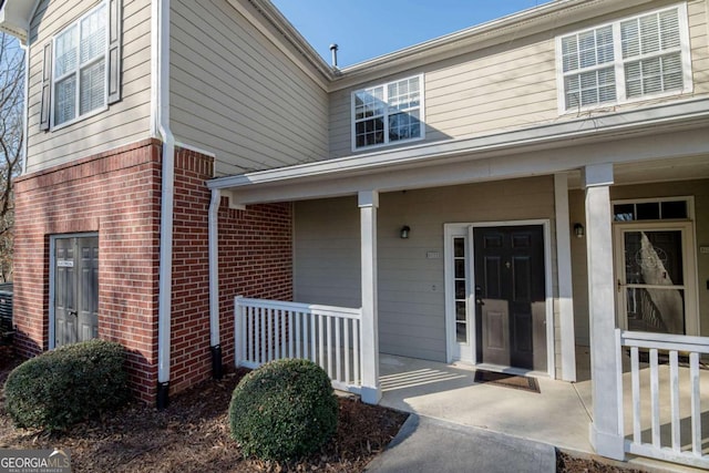 2114 Woodland Ln, Alpharetta, GA 30009 - view of exterior entry featuring covered porch and brick siding