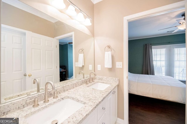 2114 Woodland Ln, Alpharetta, GA 30009 - ensuite bathroom featuring double vanity, a ceiling fan, wood finished floors, baseboards, and crown molding