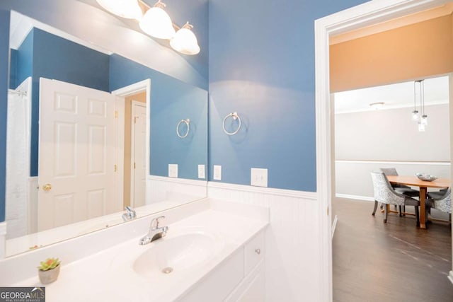 2114 Woodland Ln, Alpharetta, GA 30009 - full bath featuring a wainscoted wall, vanity, and wood finished floors