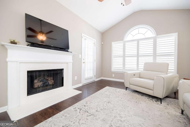 2114 Woodland Ln, Alpharetta, GA 30009 - living room featuring a ceiling fan, wood finished floors, vaulted ceiling, a fireplace with raised hearth, and baseboards
