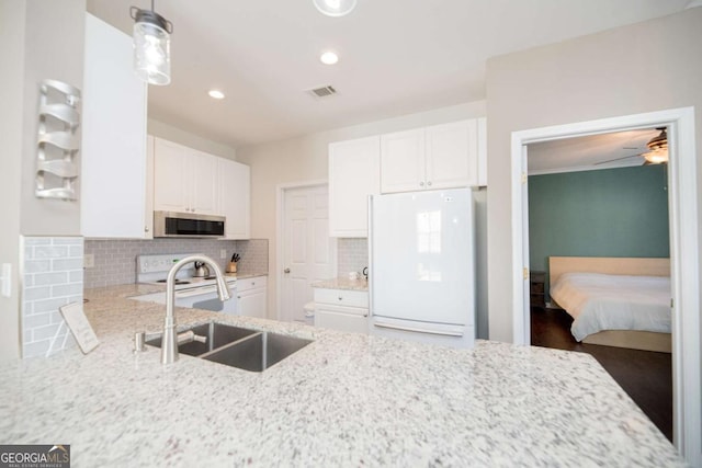 2114 Woodland Ln, Alpharetta, GA 30009 - kitchen featuring white appliances, a sink, light stone counters, backsplash, and recessed lighting