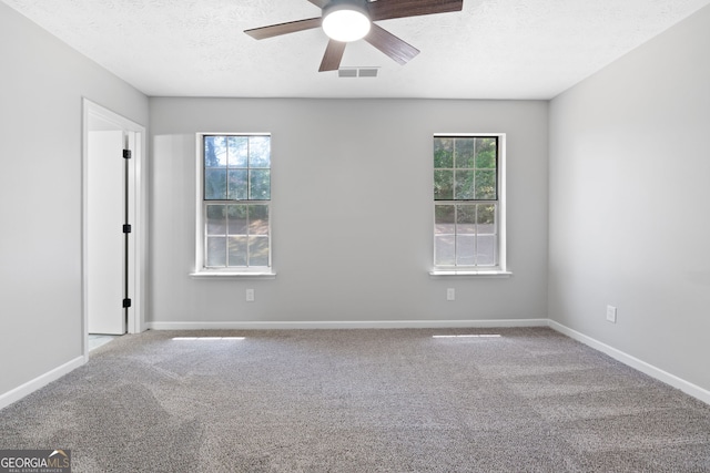 1425 Meadowind Ct SW, Conyers, GA 30094 - unfurnished room featuring a ceiling fan, carpet flooring, plenty of natural light, a textured ceiling, and baseboards
