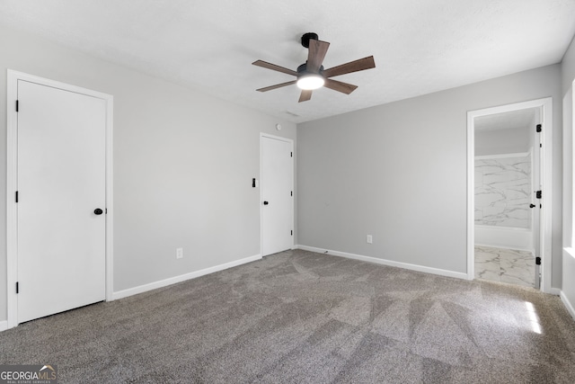 1425 Meadowind Ct SW, Conyers, GA 30094 - unfurnished bedroom featuring carpet floors, baseboards, and connected bathroom