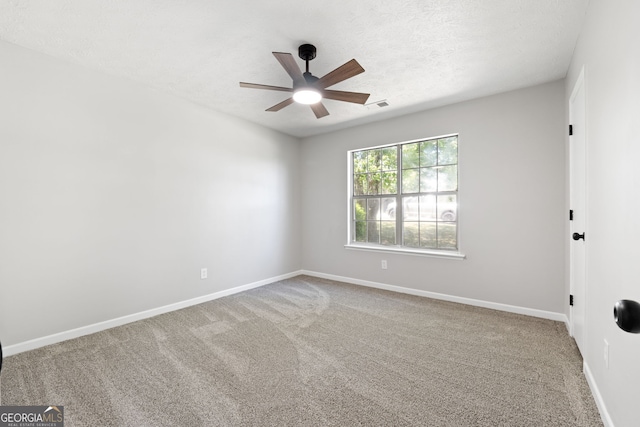 1425 Meadowind Ct SW, Conyers, GA 30094 - spare room with a ceiling fan, carpet floors, baseboards, and a textured ceiling