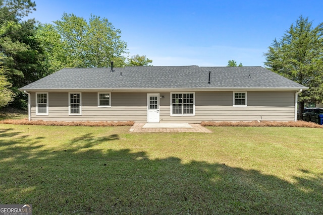 1425 Meadowind Ct SW, Conyers, GA 30094 - back of property featuring a patio area, a yard, and roof with shingles