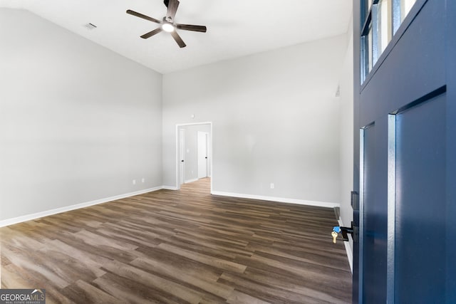 1425 Meadowind Ct SW, Conyers, GA 30094 - empty room featuring a ceiling fan, high vaulted ceiling, dark wood-type flooring, and baseboards