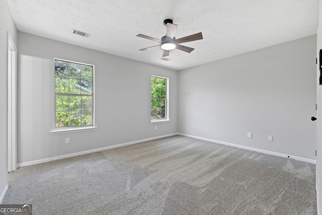 1404 Meadowind Ct SW, Conyers, GA 30094 - carpeted empty room with a ceiling fan, a textured ceiling, and baseboards