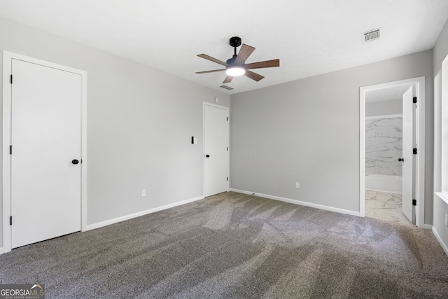 1404 Meadowind Ct SW, Conyers, GA 30094 - unfurnished bedroom featuring carpet, baseboards, connected bathroom, and marble look tile flooring