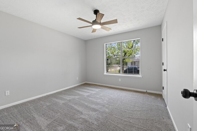 1404 Meadowind Ct SW, Conyers, GA 30094 - empty room with a ceiling fan, carpet, baseboards, and a textured ceiling
