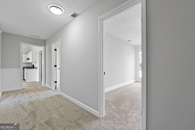 1404 Meadowind Ct SW, Conyers, GA 30094 - corridor with a textured ceiling, carpet floors, and baseboards