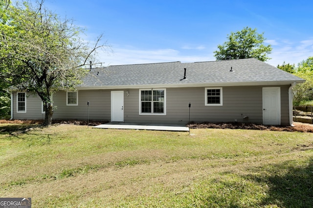 1404 Meadowind Ct SW, Conyers, GA 30094 - back of house with a shingled roof, a lawn, and a patio