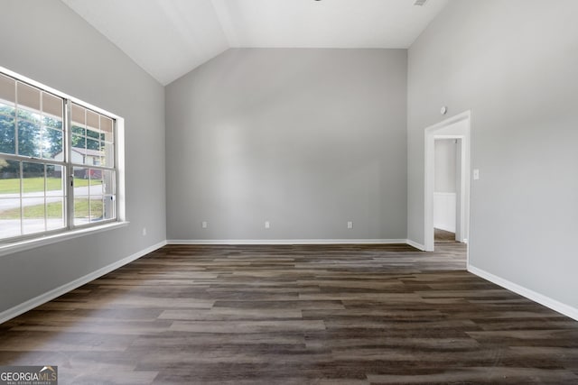 1404 Meadowind Ct SW, Conyers, GA 30094 - spare room featuring dark wood-type flooring, high vaulted ceiling, and baseboards