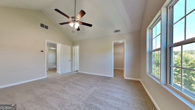 10961 Big Sky Dr, Hampton, GA 30228 - unfurnished bedroom with high vaulted ceiling, light colored carpet, a walk in closet, and ceiling fan