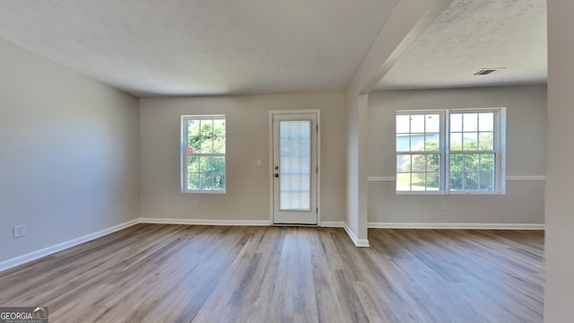 10961 Big Sky Dr, Hampton, GA 30228 - entryway featuring wood finished floors, a textured ceiling, and baseboards
