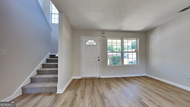 10961 Big Sky Dr, Hampton, GA 30228 - entrance foyer with wood finished floors, stairway, and a textured ceiling