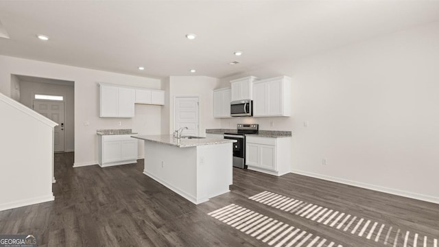 75 Poplar Blvd, Newnan, GA 30265 - kitchen featuring stainless steel appliances, a sink, baseboards, white cabinets, and a kitchen island with sink