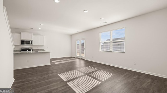 75 Poplar Blvd, Newnan, GA 30265 - unfurnished living room featuring dark wood-style flooring, baseboards, and recessed lighting