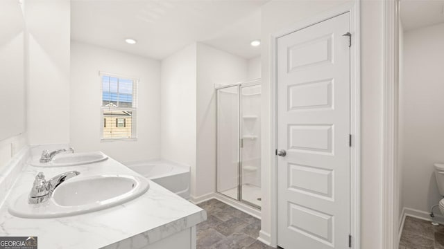 75 Poplar Blvd, Newnan, GA 30265 - bathroom featuring toilet, a stall shower, double vanity, stone finish flooring, and recessed lighting