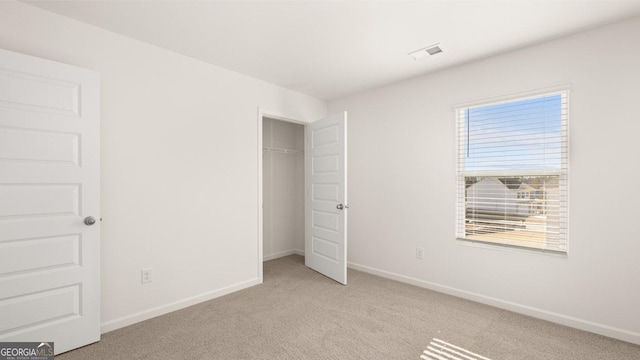 75 Poplar Blvd, Newnan, GA 30265 - unfurnished bedroom featuring light carpet, baseboards, and a closet