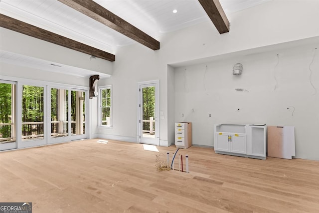 1111 Swift Crk, Greensboro, GA 30642 - unfurnished living room with beamed ceiling and light wood-type flooring