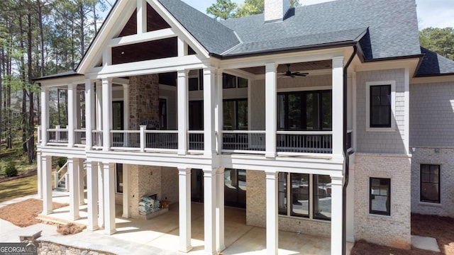 1111 Swift Crk, Greensboro, GA 30642 - rear view of house with a shingled roof, a patio, a chimney, a sunroom, and a ceiling fan