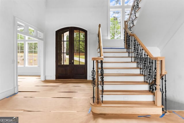 5010 Browns Ford Rd, Greensboro, GA 30642 - foyer featuring stairs, plenty of natural light, arched walkways, and a high ceiling