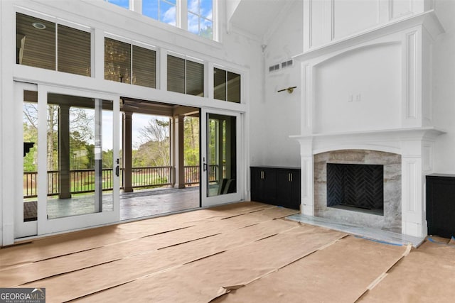 5010 Browns Ford Rd, Greensboro, GA 30642 - unfurnished living room featuring a towering ceiling and a high end fireplace