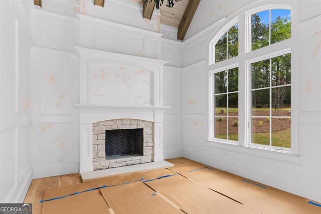 5010 Browns Ford Rd, Greensboro, GA 30642 - unfurnished living room featuring lofted ceiling, a stone fireplace, and wood finished floors