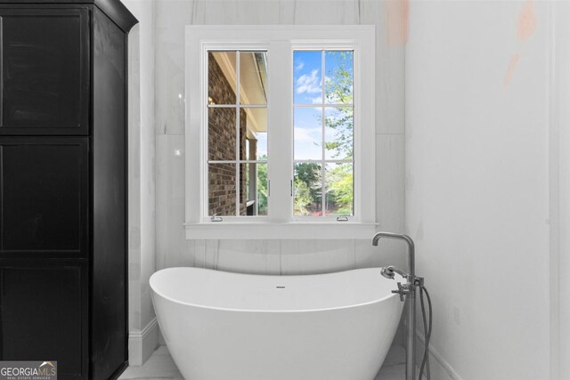 5010 Browns Ford Rd, Greensboro, GA 30642 - bathroom featuring a freestanding tub and plenty of natural light