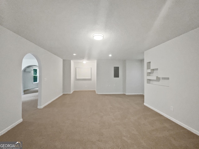 4335 Northwind Dr, Ellenwood, GA 30294 - finished below grade area with light colored carpet, baseboards, arched walkways, and recessed lighting