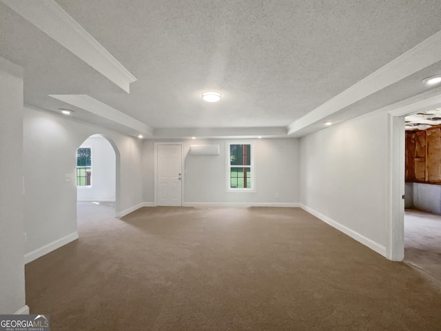 4335 Northwind Dr, Ellenwood, GA 30294 - carpeted empty room with arched walkways, a textured ceiling, an AC wall unit, baseboards, and recessed lighting