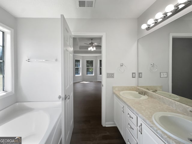 4335 Northwind Dr, Ellenwood, GA 30294 - bathroom with healthy amount of natural light, wood finished floors, ceiling fan, and double vanity