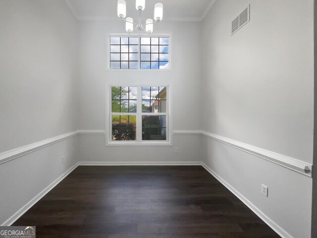 4335 Northwind Dr, Ellenwood, GA 30294 - unfurnished dining area featuring a chandelier, dark wood-style floors, crown molding, and baseboards