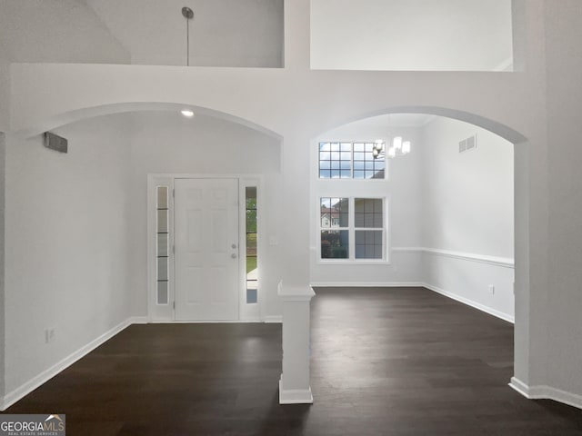 4335 Northwind Dr, Ellenwood, GA 30294 - entrance foyer with wood finished floors, baseboards, arched walkways, and a chandelier