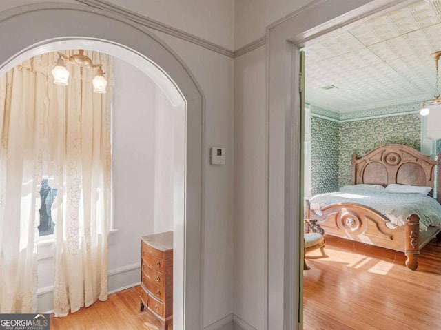 3021 Teamon Rd, Griffin, GA 30223 - bedroom with arched walkways, hardwood / wood-style flooring, baseboards, and wallpapered walls