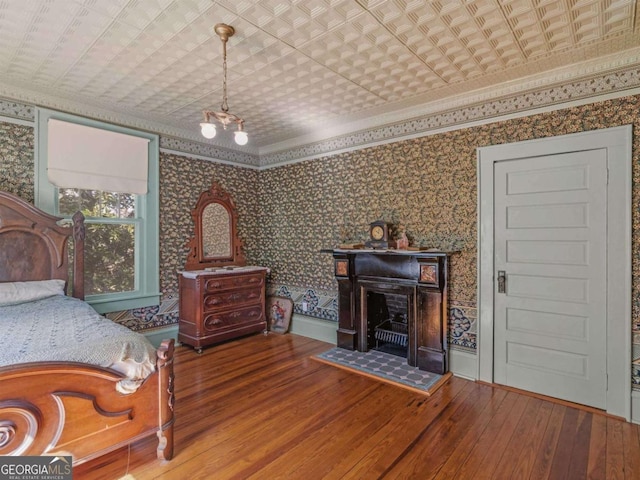 3021 Teamon Rd, Griffin, GA 30223 - bedroom featuring hardwood / wood-style flooring, wallpapered walls, a fireplace, an ornate ceiling, and ornamental molding