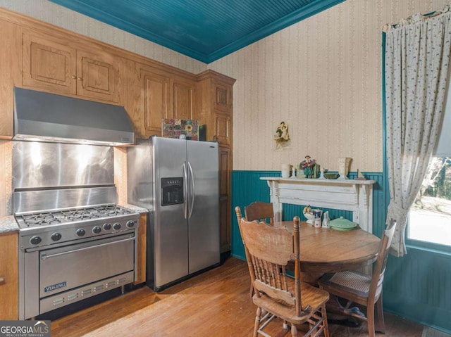 3021 Teamon Rd, Griffin, GA 30223 - kitchen featuring appliances with stainless steel finishes, under cabinet range hood, light wood-type flooring, brown cabinets, and light countertops