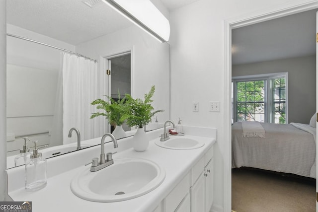 full bath featuring double vanity and ensuite bath