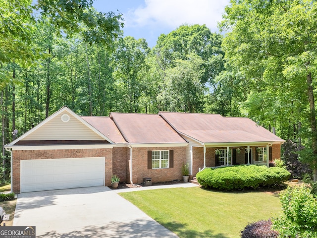 ranch-style house with brick siding, an attached garage, driveway, and a front yard
