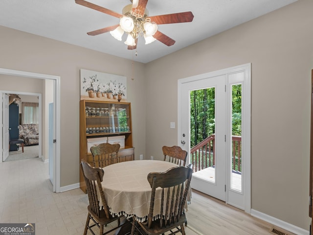 dining space featuring baseboards and ceiling fan