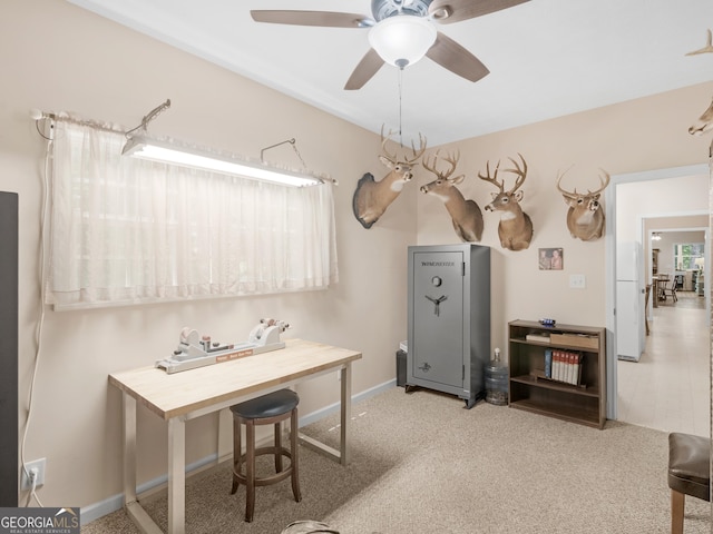 home office with a ceiling fan, carpet floors, and baseboards