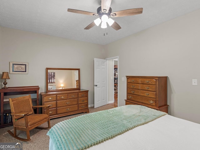 carpeted bedroom with baseboards and ceiling fan