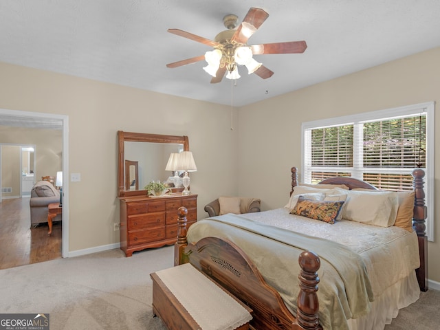 carpeted bedroom featuring baseboards and a ceiling fan
