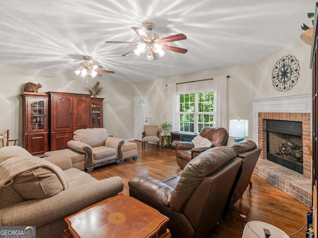 175 N Unity Grove Rd, Locust Grove, GA 30248 - living area with wood finished floors, a brick fireplace, and ceiling fan